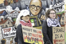 Attendees met by large signs calling out Microsoft's complicity in war crimes and climate devastation