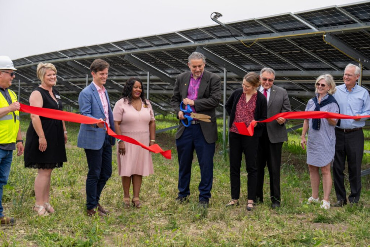 In the center, cutting the ribbon of a new solar operation is Galesburg Illinois Mayor Peter Schwartzman in 2023.