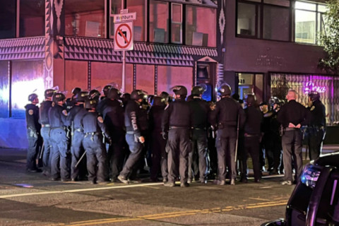 about 20 individual cops visible in the frame