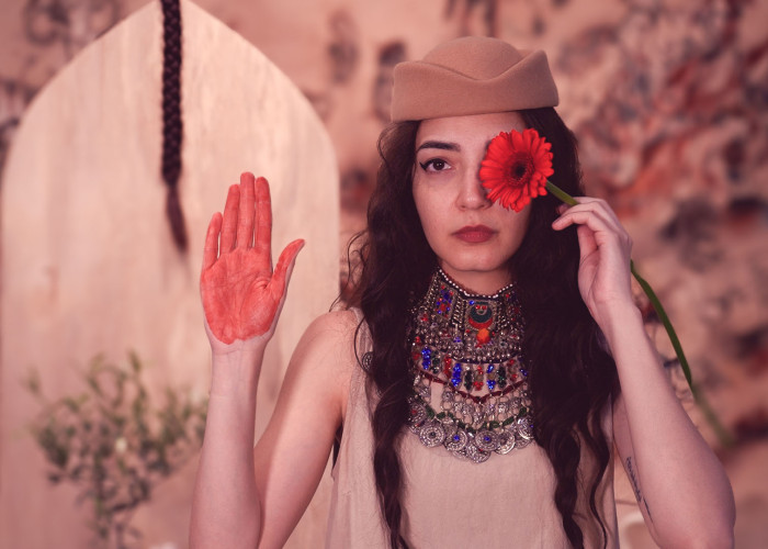 Image showing woman with flower and red hand