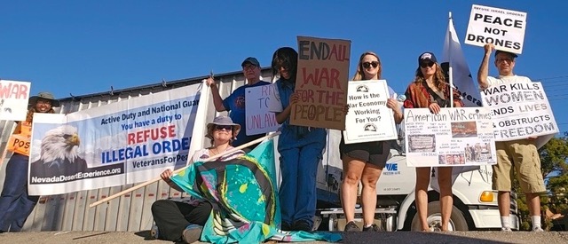 Group of anti-war protesters holding signs