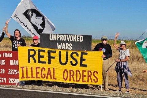 Group of anti-war protesters holding signs