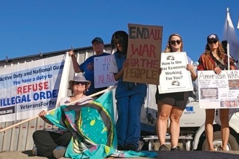 Group of anti-war protesters holding signs