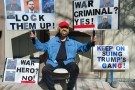 A Utah neighborhood uses garage doors as a backdrop to display signs commenting on the Trump Administration's performance.