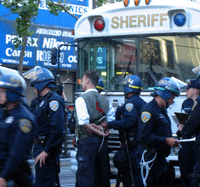 Medic arrested at June 8th protest is about to be loaded into an SF Sheriff's bus
